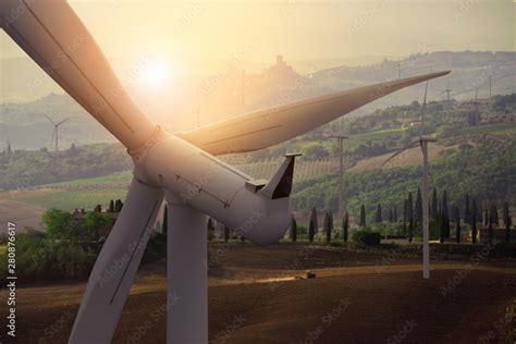 Wind turbine farm power generator in beautiful nature landscape for production of renewable ...