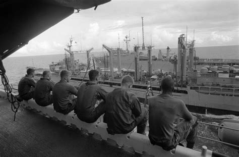 Crew members aboard the amphibious assault ship USS BELLEAU WOOD (LHA 3) take a break to observe ...