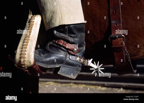 Cowboy boot and spurs in horse saddle stirrup Stock Photo - Alamy