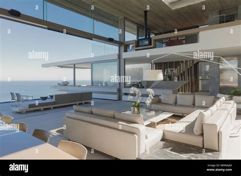 Modern, luxury home showcase interior living room with ocean view Stock Photo - Alamy