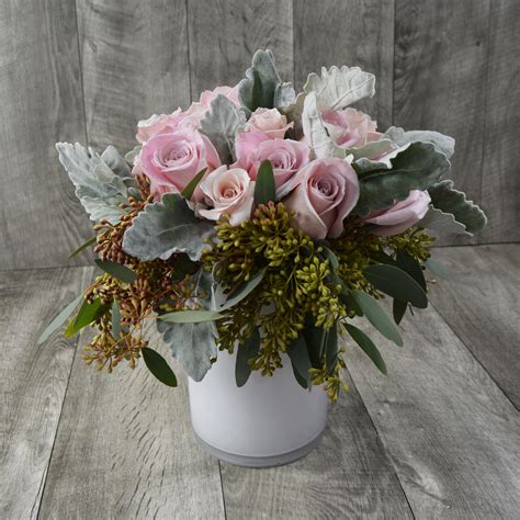 An elegant bouquet of pastel roses, dusty miller, and eucalyptus is perfect for modern home deco ...