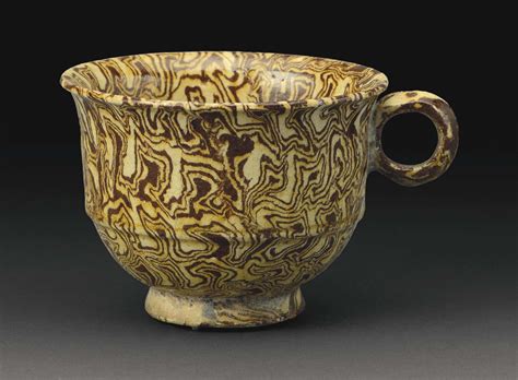 A RARE YELLOW-GLAZED MARBLED POTTERY CUP TANG DYNASTY (AD 618-907) https://www.christies.com/img ...