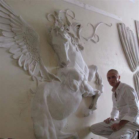 a man standing next to a white horse sculpture on the side of a wall in front of a window