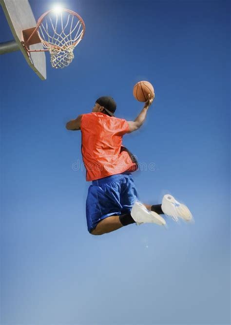 Man Dunking a Basketball stock photo. Image of blue, dunk - 33783560