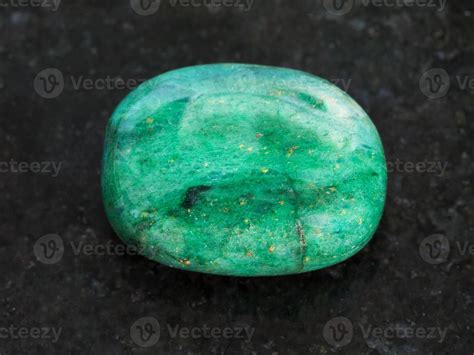 polished green beryl gemstone on dark background 14937599 Stock Photo at Vecteezy