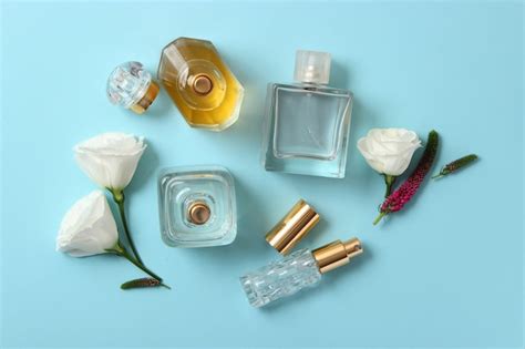 Premium Photo | Perfume and flowers on a colored background