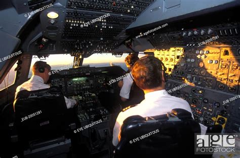 South African Airways Boeing 747 300 cockpit with pilot and crew at daybreak over central Africa ...