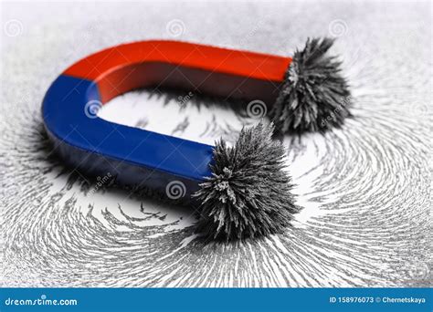 Red And Blue Horseshoe Magnets Attracting Colorful Paperclips On Light ...