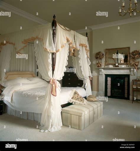 Silk edged white canopy and curtains on four poster bed with white Stock Photo, Royalty Free ...