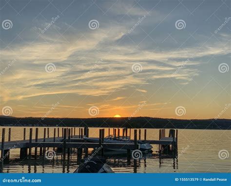 Lake dock at sunset stock image. Image of dock, sunset - 155513579