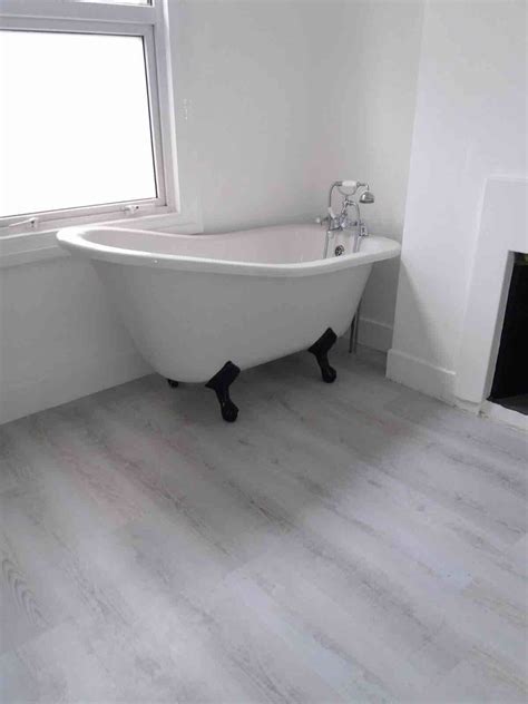 Fitting of Luxury Vinyl Tiles (LVT) in bathroom area for preparation ply boarding and fitting of ...