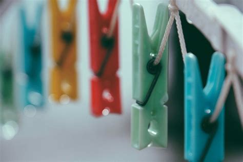 Row of multicolored clothes pegs on clothesline · Free Stock Photo