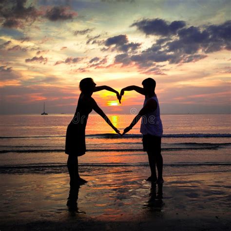 Young Couple Holding Hands Heart-shaped at Sunset Stock Photo - Image of married, adult: 28055826