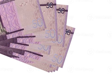 50 Dominican pesos bills lies in small bunch or pack isolated on white. Mockup with copy space ...