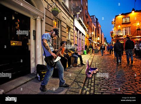 Band busking in cobbled street of Temple Bar nightlife area Dublin ...