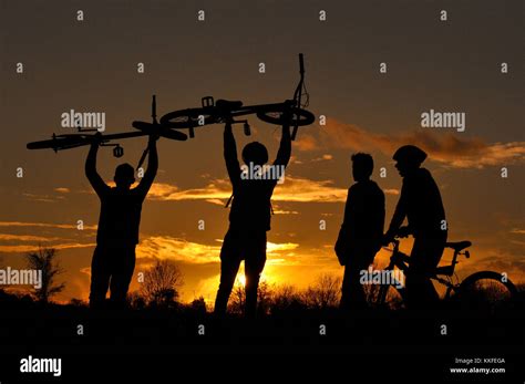 Mountain Bikers in silhouette Stock Photo - Alamy