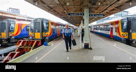 Trains sit in the platform at Portsmouth Harbour Railway Station Stock Photo - Alamy