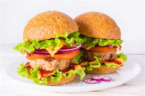 Premium Photo | Two appetizing hamburgers on a plate on a table