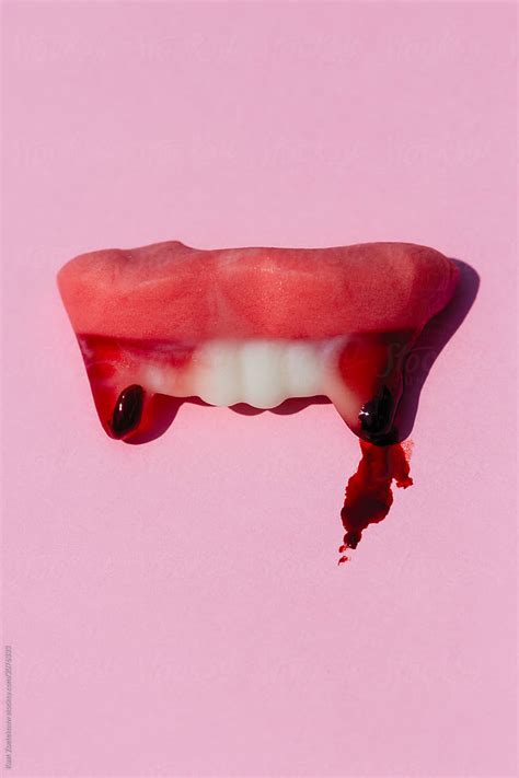 "Halloween Themed Vampire Teeth Candy With Blood" by Stocksy Contributor "Kaat Zoetekouw" - Stocksy