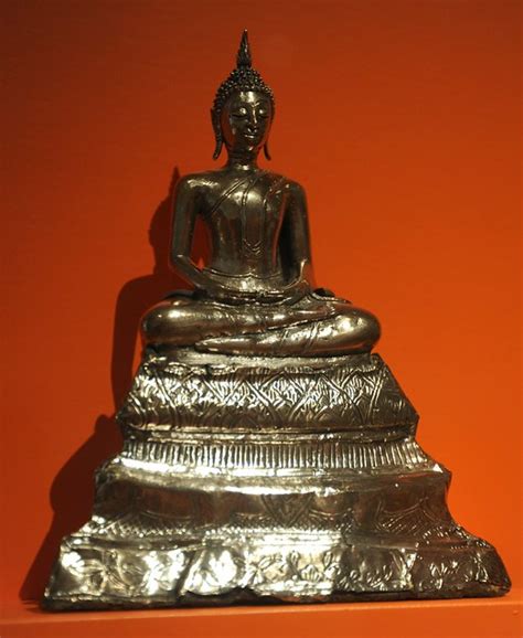 Enlightened Buddha sitting happily in meditation, (Amitabha), long ears, flame of aura on his ...