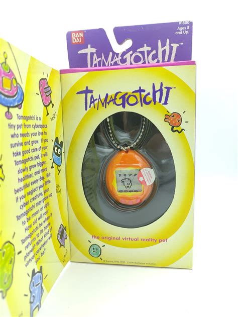 Tamagotchi Original P1/P2 orange w/ yellow Bandai 1997 English - Boutique-Tamagotchis