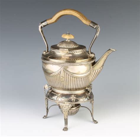 Lot 459, A Victorian silver tea kettle on stand with burner, having ...