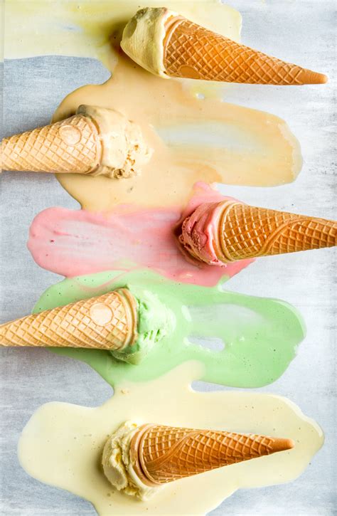 Colorful ice cream cones of different flavors. Melting scoops. Top view, steel metal background ...