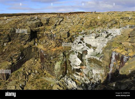 A frozen Kinder Downfall waterfall, Kinder Scout, Pennine Way, Peak District National Park ...