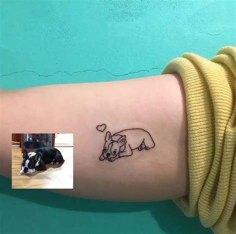a small dog tattoo on the arm