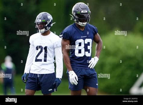 Seattle Seahawks cornerback Devon Witherspoon (21) and wide receiver Dareke Young (83) stand on ...