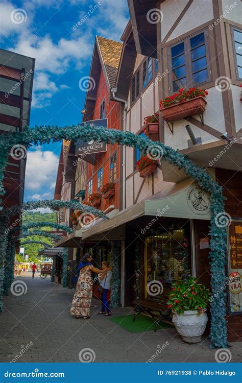 BLUMENAU, BRAZIL - MAY 10, 2016: Unidentified Womens Waiting Outside a Store in a Small Street ...