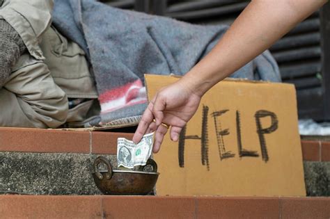 Premium Photo | Giving money to homeless men on the side of the road.