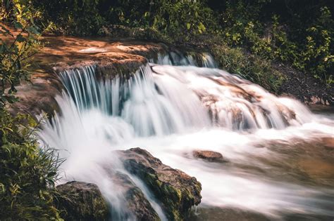 Time lapse Photo of Waterfall Surrounded by Grass · Free Stock Photo