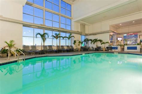 The indoor pool and surrounded by palms in a four story atrium in the ...