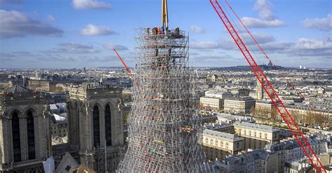 notre-dame’s spire is finally installed, one year before the cathedral’s scheduled opening