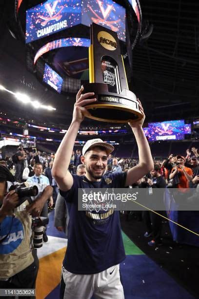 Ty Jerome of the Virginia Cavaliers celebrates with the trophy after ...