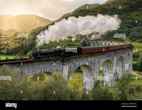 Steam train crossing the Glenfinnan viaduct in the Scottish Highlands ...