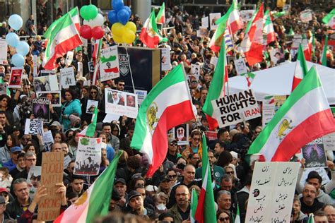 Crowd of People Protesting on Street Holding Flags and Posters · Free ...