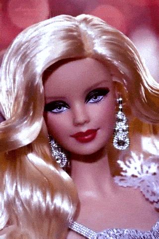 a barbie doll with blonde hair and blue eyes wearing a tiara, earrings and dress