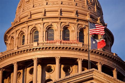 Close-up of the State Capitol Dome in Austin, Texas with the USA and Texas Lone Star Flags ...