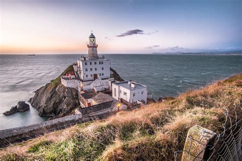 Sunrise in Baily lighthouse Dublin Ireland Photograph by Giuseppe Milo | Pixels