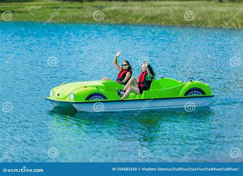 Girls in Safety Jackets Wave and Ride a Pedal Boat on a Mountain Lake Stock Photo - Image of ...