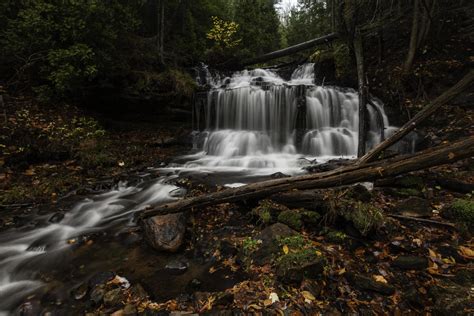 Waterfall in a dark forest 1312967 Stock Photo at Vecteezy