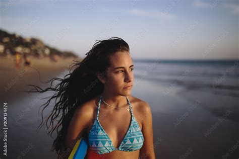 Cute teen girl with a bodyboard at the beach Stock Photo | Adobe Stock