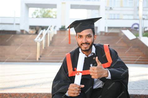 Premium Photo | Young indian graduated boy holding his graduation ...