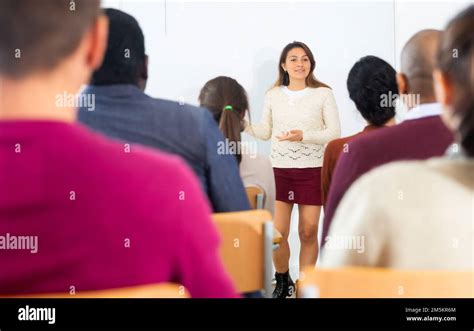 Teacher standing in front Of whiteboard and teaching lesson Stock Photo - Alamy