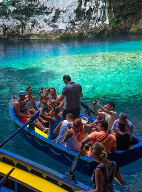 Premium Photo | Tour by boat tourists in a cave with an underground ...