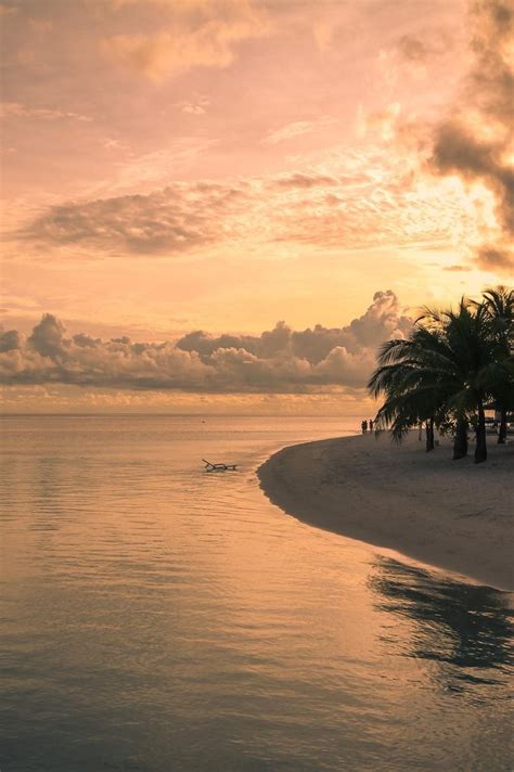 Sunset over an island in the Maldives. | Dream vacations, Beautiful beaches, Sunset