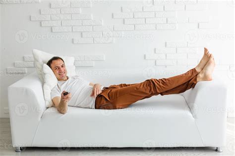 Mature Man On Couch Watching Television 16479048 Stock Photo at Vecteezy