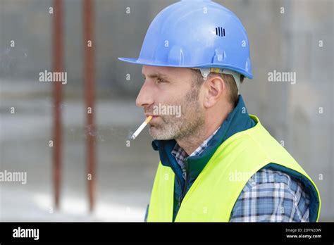 builder smoking cigarette on construction site Stock Photo - Alamy